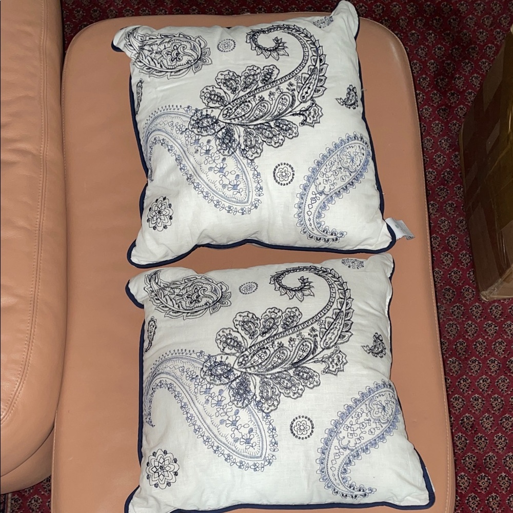 Two Cindy Crawford throw pillows, white with blue paisley stitching